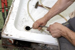 Plumber Using Drain Snakes