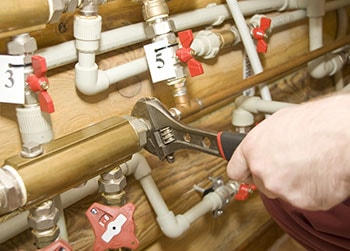 Plumber Servicing Water and Heating Systems