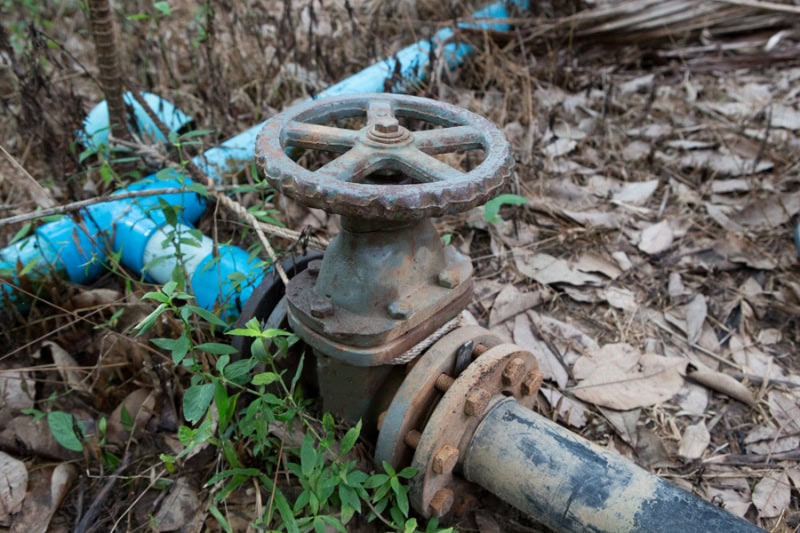 Water valve connected to pipe and releasing sewer odors.