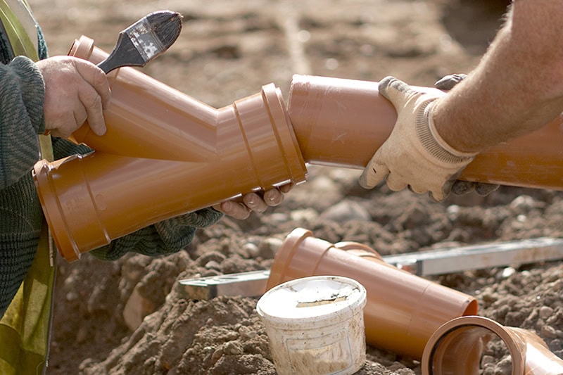 Plumbers cleaning sewer line in Pasadena, MD.